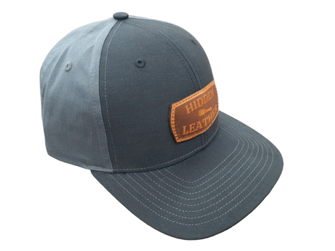 Richardson hat with charcoal black front and dark gray back. With custom leather laser engraved patch sewn onto the front