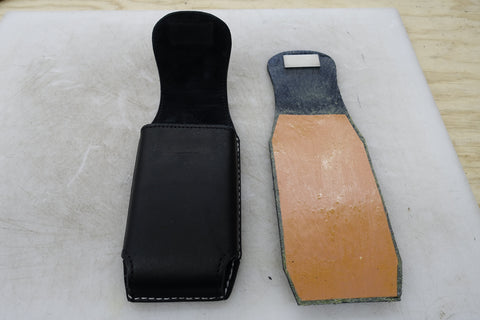 Black custom leather cell phone case/holster showing the layer of EMF protective material glued inside.